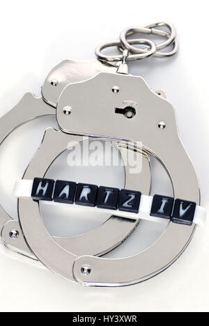 Handcuffs and Hartz IV stroke, working duty for Hartz IV receiver, Handschellen und Hartz IV-Schriftzug, Arbeitspflicht fuer Hartz IV-Empfaenger Stock Photo