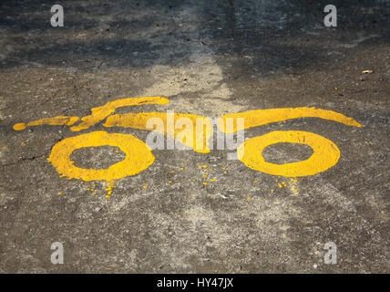 yellow paint of motorcycle parking symbol on floor Stock Photo