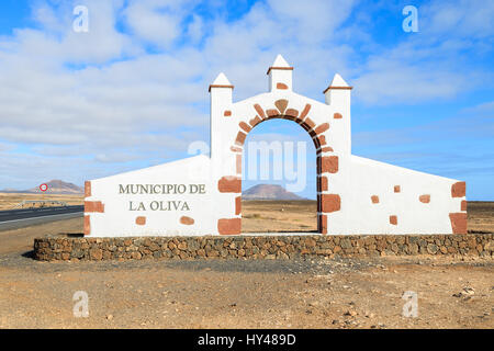 Typical municipality sign (white arch gate) in La Oliva village with desert landscape in the background, Fuerteventura, Canary Islands, Spain Stock Photo