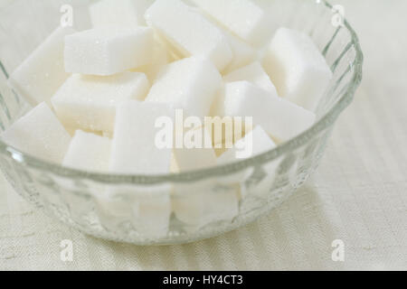 Closeup of cubes of white sugar in a crystal bowl Stock Photo