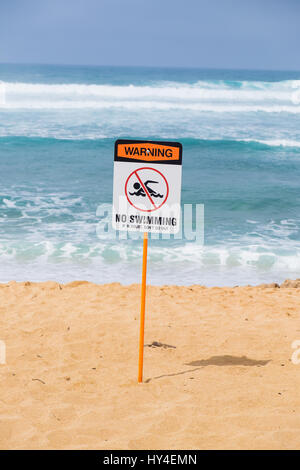 Storng current no swimming sign in front of a popular surf spot at Haleiwa Beach on Oahu Hawaii. Stock Photo