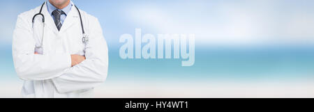 Portrait of a smiling male doctor standing with arms crossed in the hospital Stock Photo