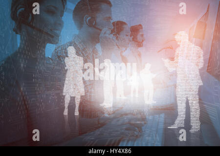 Business team working at the call centre  against shiny silhouettes on blue background Stock Photo
