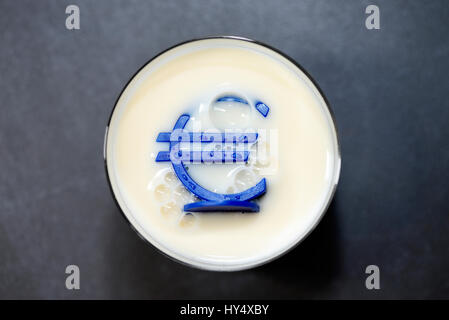 Eurosign sinks into a milk glass, low milk prices, Eurozeichen versinkt in einem Milchglas, niedrige Milchpreise Stock Photo
