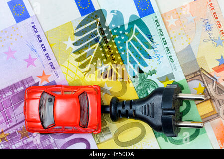 Miniature car with plug on euronotes and federal eagle, purchase premium for electric cars, Miniaturauto mit Stecker auf Euroscheinen und Bundesadler, Stock Photo