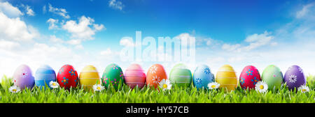 Easter Banner - Colorful Painted Eggs In Row On Grass Stock Photo