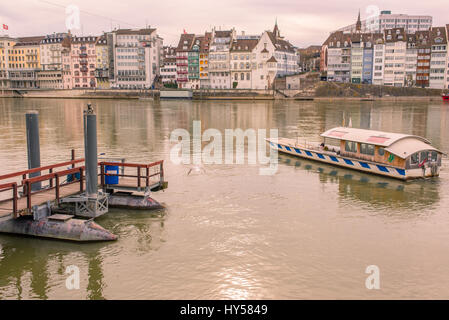 “Vogel Gryff” ferry boat on Basel riverfront opposite Basel's Altstadt ('old town'). It transports passengers across the Rhine without motorised assis Stock Photo