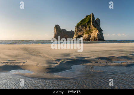 Rock island on Wharariki beach, Wharariki Beach, Golden Bay, Southland, New Zealand Stock Photo