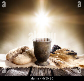 Communion - Unleavened Bread With Chalice Of Wine And Cross Light Stock Photo