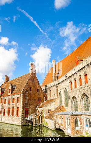 Colorful medieval building by canal in Bruges - Belgium Stock Photo