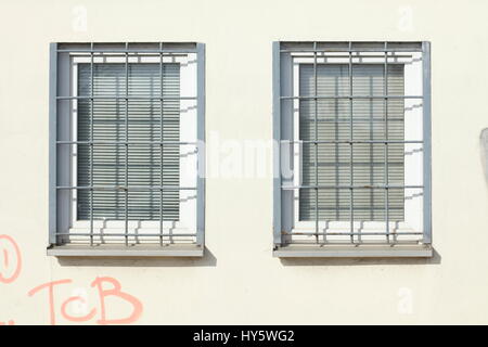 Windows with grids and pulled down shutters Stock Photo