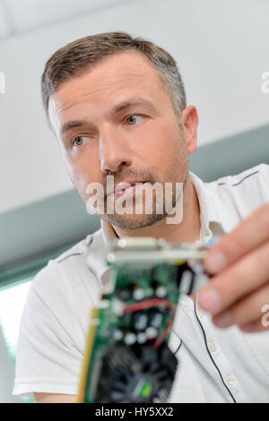 IT expert holding a graphics card Stock Photo