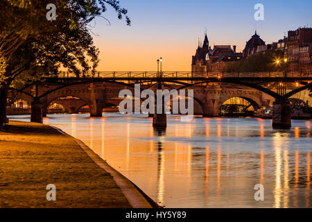 Sunrise on the Seine River banks, Pont des Arts and Pont Neuf in the 1st Arrondissement of Ile de la Cite, Paris, France Stock Photo
