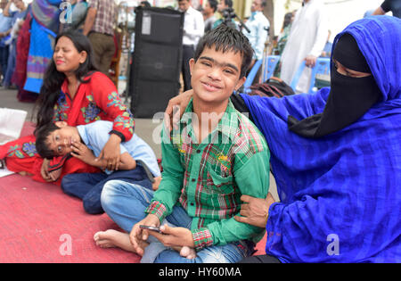 DHAKA, BANGLADESH – APRIL 01, 2017: Bangladeshi autistic children sit with their parent as they come to attend an art camp on the day of World Autism  Stock Photo