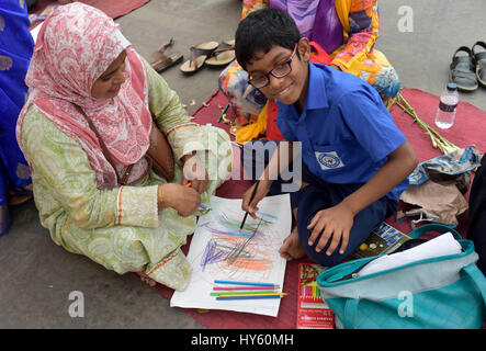 DHAKA, BANGLADESH – APRIL 01, 2017: Bangladeshi autistic children paint as they attend an art camp on the day of World Autism Awareness Day in Dhaka,  Stock Photo