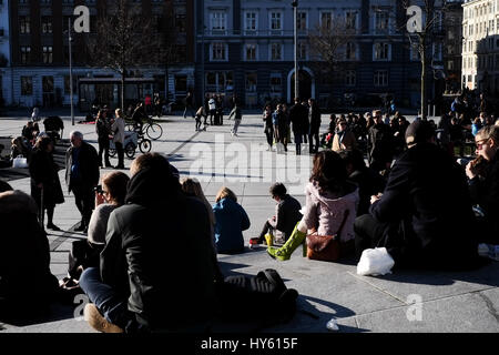 Crowds enjoy a strong springtime sun in Israels plads near Torvehallerne market, Nørreport, Copenhagen, Denmark Stock Photo