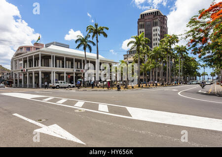 PORT LOUIS, MAURITIUS - NOVEMBER 18, 2016: People walk in the street of Port Louis lined with international banks in Mauritius. The city is an importa Stock Photo