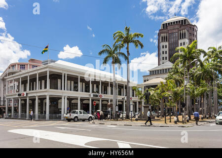 PORT LOUIS, MAURITIUS - NOVEMBER 18, 2016: People walk in the street of Port Louis lined with international banks in Mauritius. The city is an importa Stock Photo