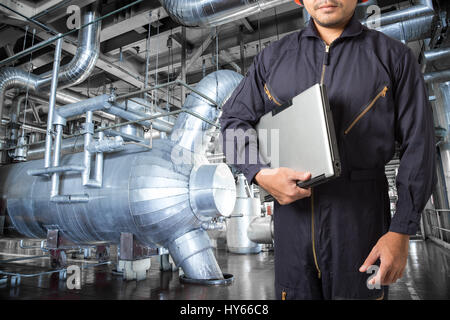 Engineer using laptop computer in the factory Stock Photo