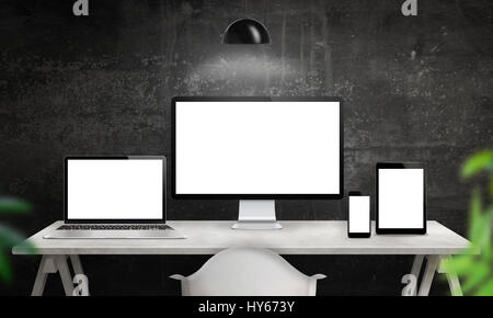 Different devices on desk with isolated screen for responsive web site design promotion. Computer display, laptop, tablet and smart phone mockup. Stock Photo