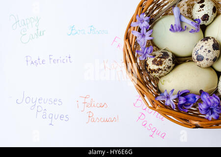 Eggs and Happy Easter note in different languages Stock Photo