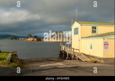 Boat houses at Otago Peninsula and Otago Harbour during sunset east of Dunedin, New Zealand Stock Photo