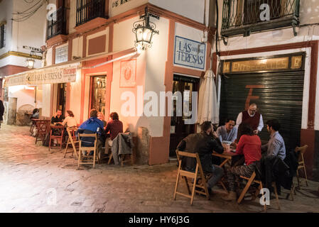 Tourists enjoying an evening meal at one of the many restaurants in Seville Old Town, Seville, Spain. Stock Photo