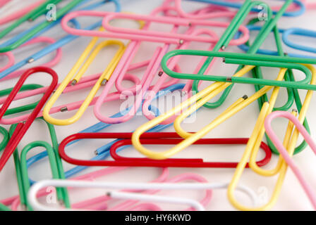 Close-up of multi-colored paper clips on a white background. Stock Photo