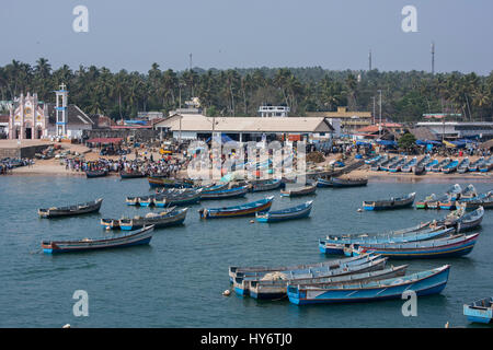 India, state of Kerala, Malabar Coast, port city of Villanjam aka Vizhinjam along the coast of the Arabian Sea. Traditional wooden fishing boats, crow Stock Photo