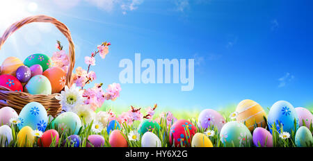 Easter Eggs In Basket And On Meadow Stock Photo