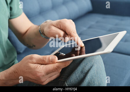 Man holding digital tablet in hands, closeup Stock Photo
