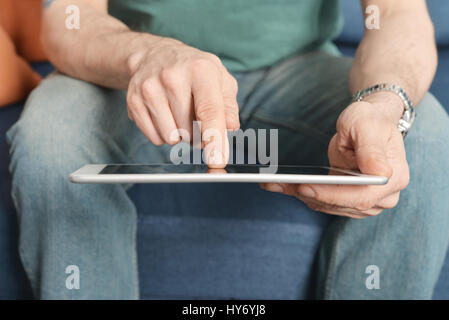 Man holding digital tablet in hands, closeup Stock Photo