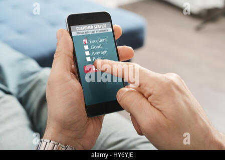 Online customer service satisfaction survey on a mobile phone Stock Photo