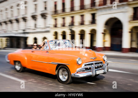 Classic car driving through Havana, Cuba Stock Photo