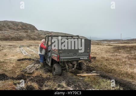 ATV stuck up to the tie rods in water-logged peat, Quirpon Island, Newfoundland Stock Photo