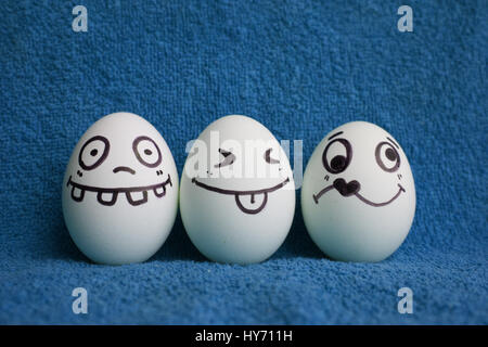 Eggs with faces photo for your design. With a place under the text. Funny and cute. Three eggs head all around from love Stock Photo