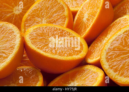 Fresh cut half oranges full frame close up Stock Photo