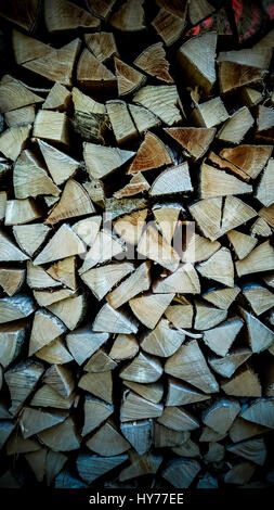 Neatly stacked firewood as background, soft focus Stock Photo