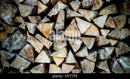 Neatly stacked firewood as background, soft focus Stock Photo
