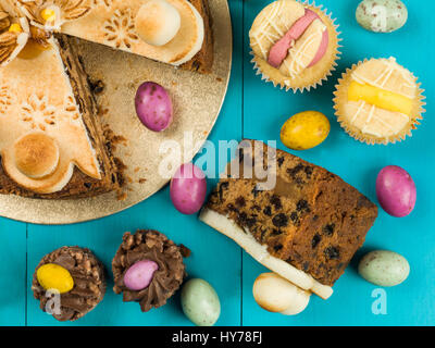 Traditional Easter Sunday Afternoon Tea and Cakes Against a Blue Background Stock Photo