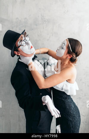 Two pantomime theater artists performing. Mime actors with white makeup masks on faces Stock Photo