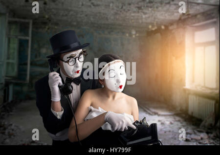 Pantomime theater actor and actress performing. Mime artists with white makeup masks on faces Stock Photo