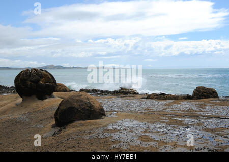 Remains of the Katiki boulders on the beach near Shag Point, Their more famous cousins are some 12 km north of these at Moeraki. Stock Photo