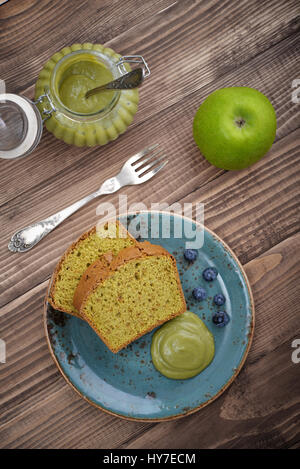 Pound cake with tea matcha curd on plate top view Stock Photo