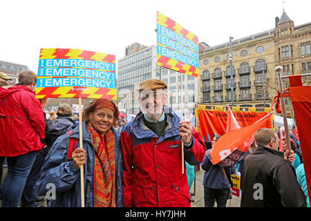 Leeds, UK. 1st April, 2017. Campaigners holding placards which read 'Emergency' Leeds, 1st April, 2017 (C)Barbara Cook/Alamy Live News Credit: Barbara Cook/Alamy Live News Stock Photo