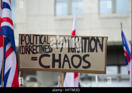 London, UK. 1st April, 2017.  The English Defence League (EDL) and Britain First held a protest march through London. The Britain First group were protesting against terrorism in response to the reason terrorist attack in London on March the 22nd 2017. Political correctness + migration = chaos placard held at the march. Andrew Steven Graham/Alamy Live News Stock Photo