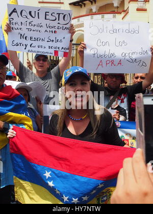 Woman carrying Venezuelan flag when dozens of Venezuelans took to the