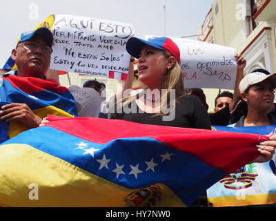 Woman carrying Venezuelan flag when dozens of Venezuelans took to the