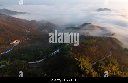 Huoshan. 2nd Apr, 2017. Aerial photo taken on April 2, 2017 shows the sea of clouds over Wangjiachong Village near Dabie Mountains in Huoshan County, east China's Anhui Province. Credit: Tao Ming/Xinhua/Alamy Live News Stock Photo
