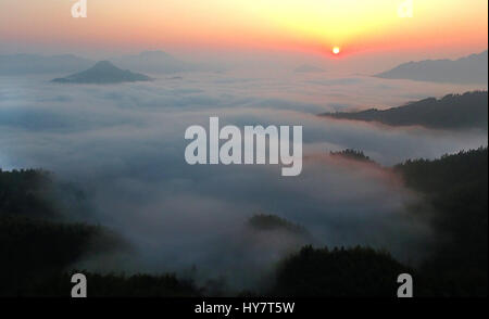 Huoshan, China's Anhui Province. 2nd Apr, 2017. Sun rises from the sea of clouds over Wuji Mountain in Huoshan County, east China's Anhui Province, April 2, 2017. Credit: Tao Ming/Xinhua/Alamy Live News Stock Photo